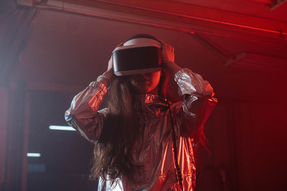 woman in white long sleeve shirt wearing black and white vr goggles