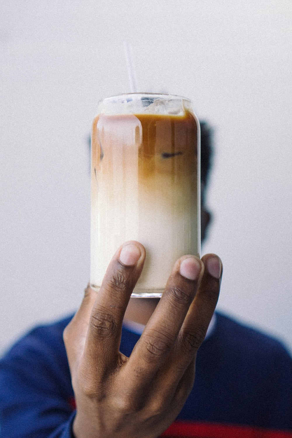 person holding clear plastic cup