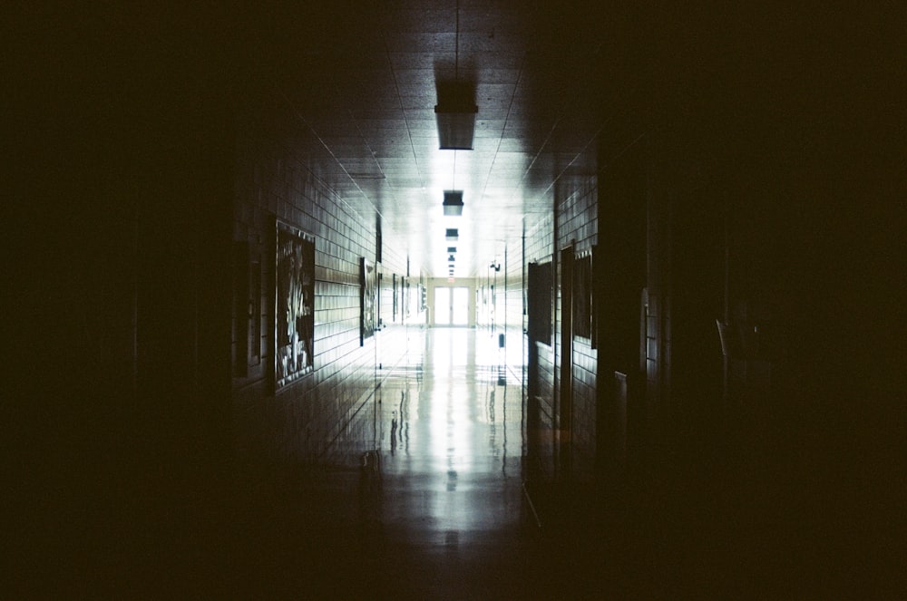 grayscale photo of tunnel with light