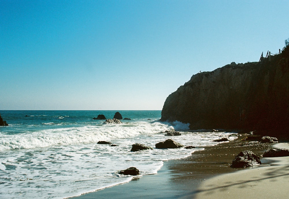 brown rock formation on sea during daytime