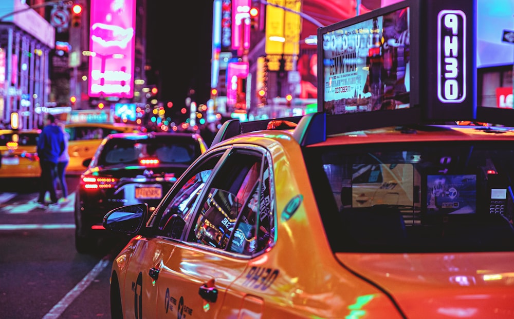 yellow taxi cab on the street during night time