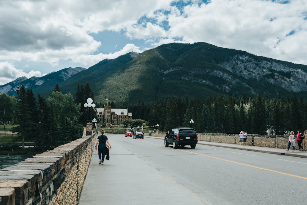 black suv on road near green mountain during daytime