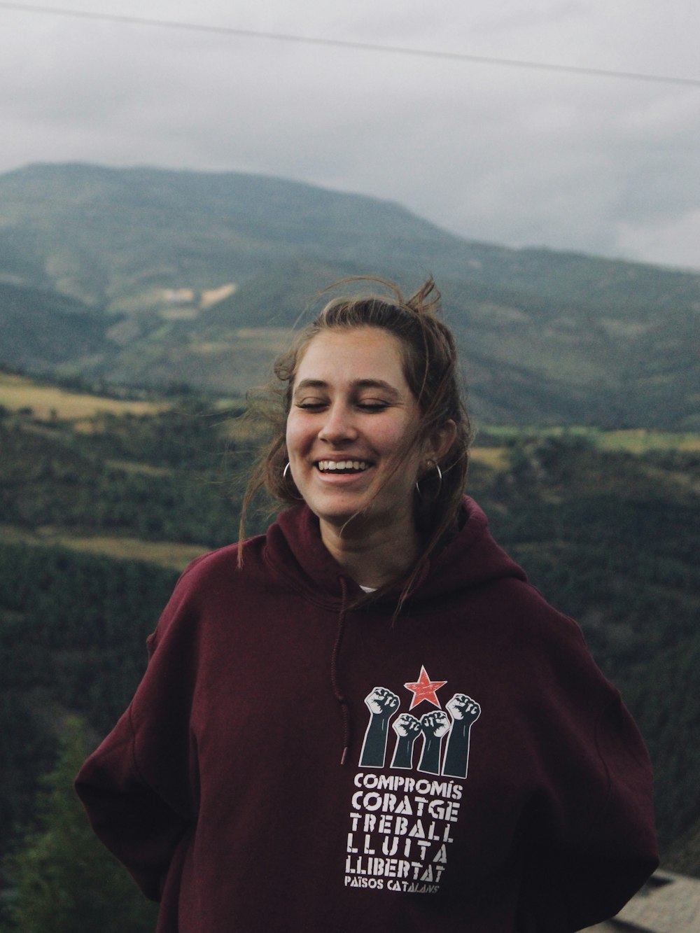 woman in red hoodie smiling