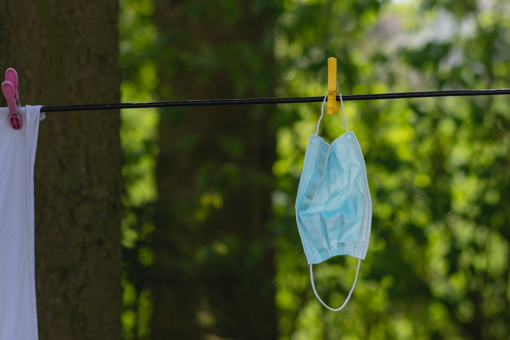 white textile on brown wooden clothes hanger