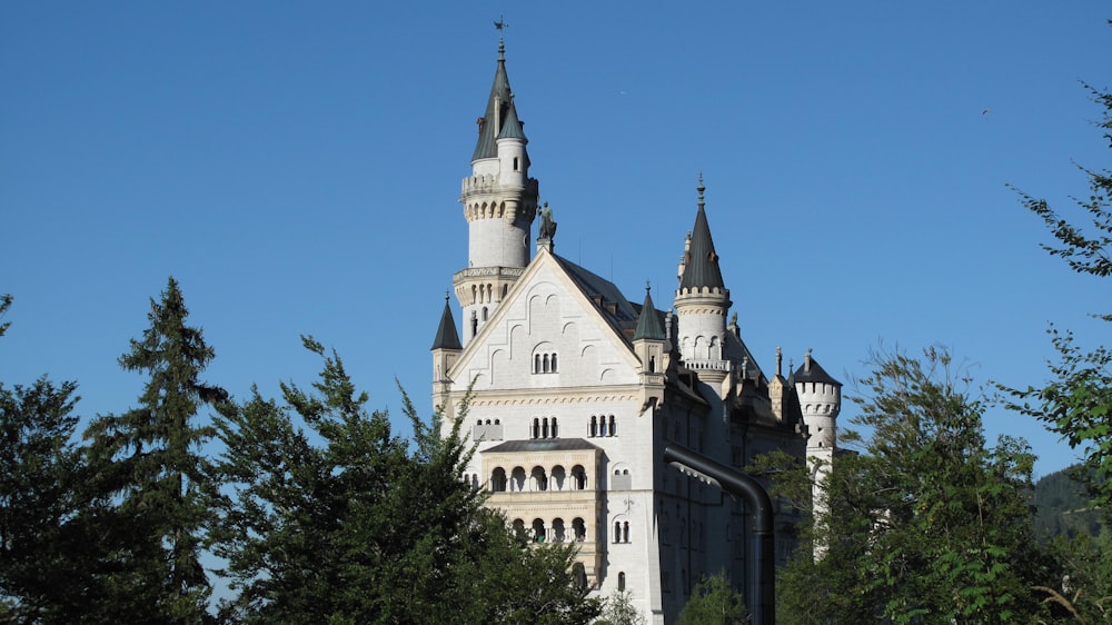 white and gray concrete castle under blue sky during daytime