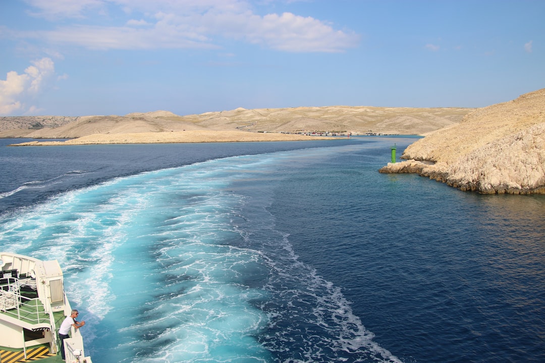 On a car ferry in Croatia. View of the island Rab, on the route between Stinica and Misnjak. On this side the island is rocky with sparse vegetation. Croatia, Balkans, South-east Europe.