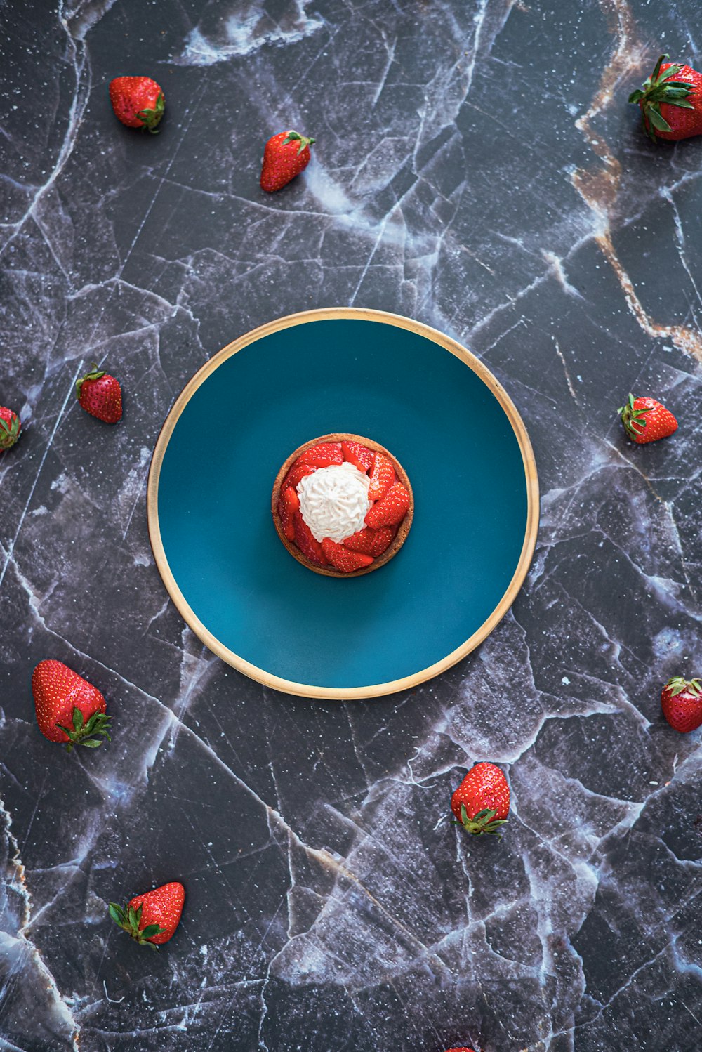 strawberries on yellow and blue ceramic plate