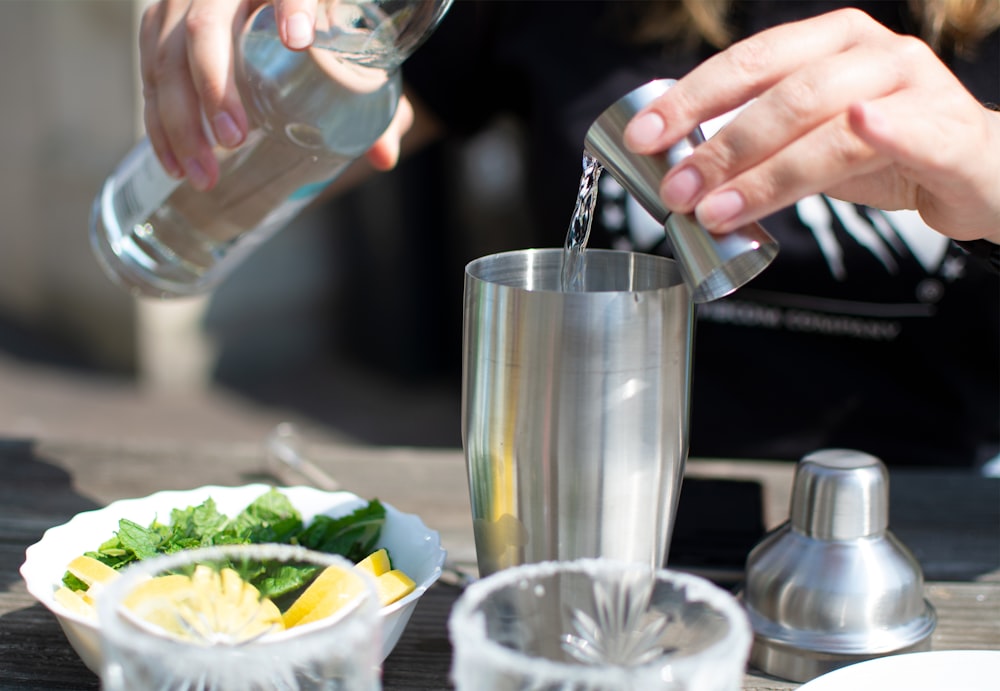 person holding clear drinking glass