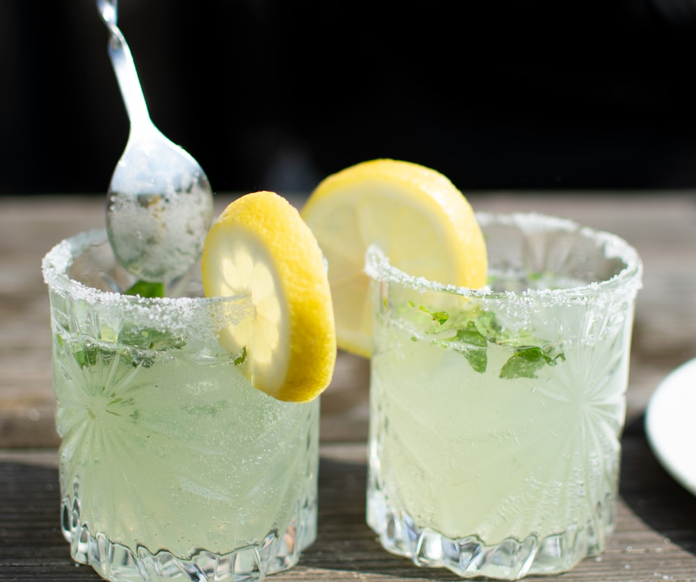 ice in clear drinking glass with ice cubes and sliced lemon