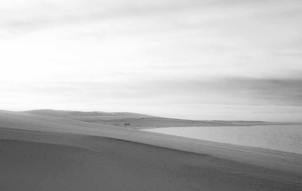 grayscale photo of sand dunes