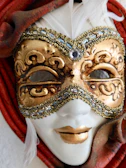 Close-up of a Mahalakshmi face mask with pearl and kundan detailing on a marble finish.