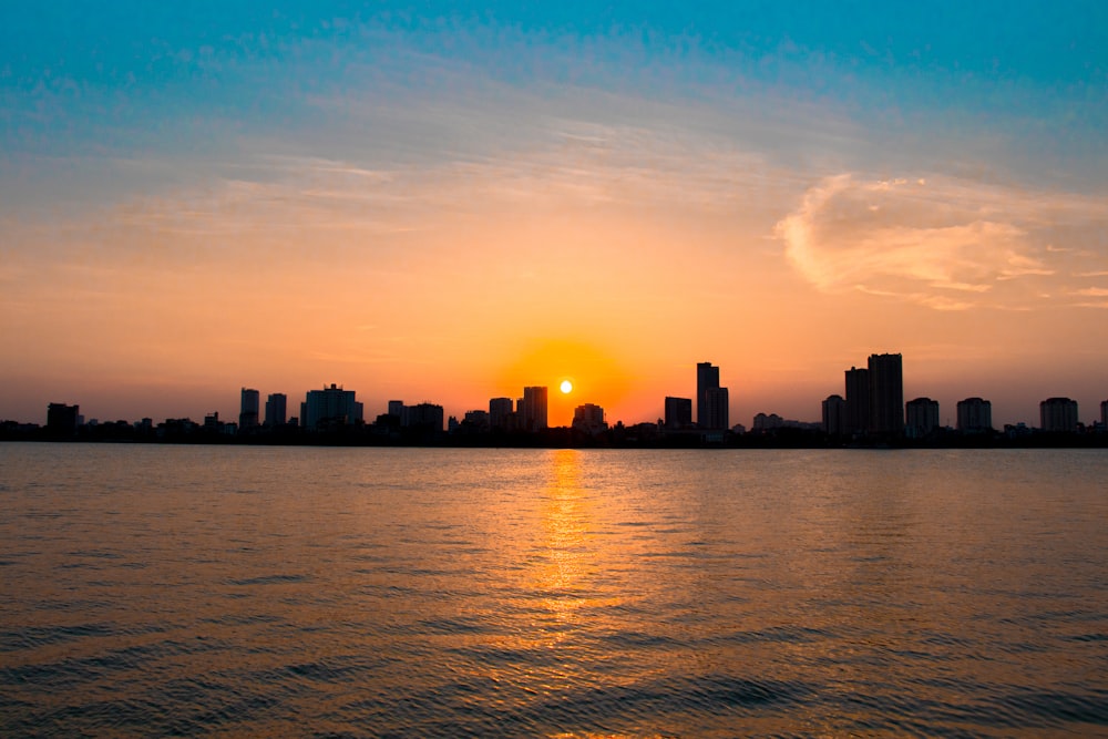 silhouette of city buildings during sunset