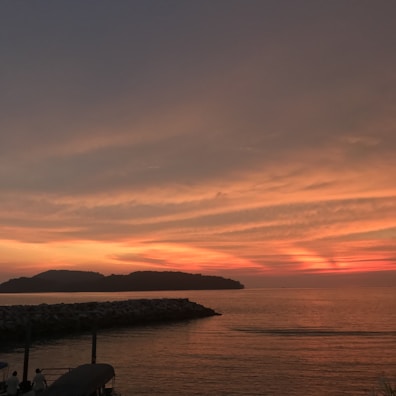 Sunset over a calm sea, highlighting peaceful travel moments.