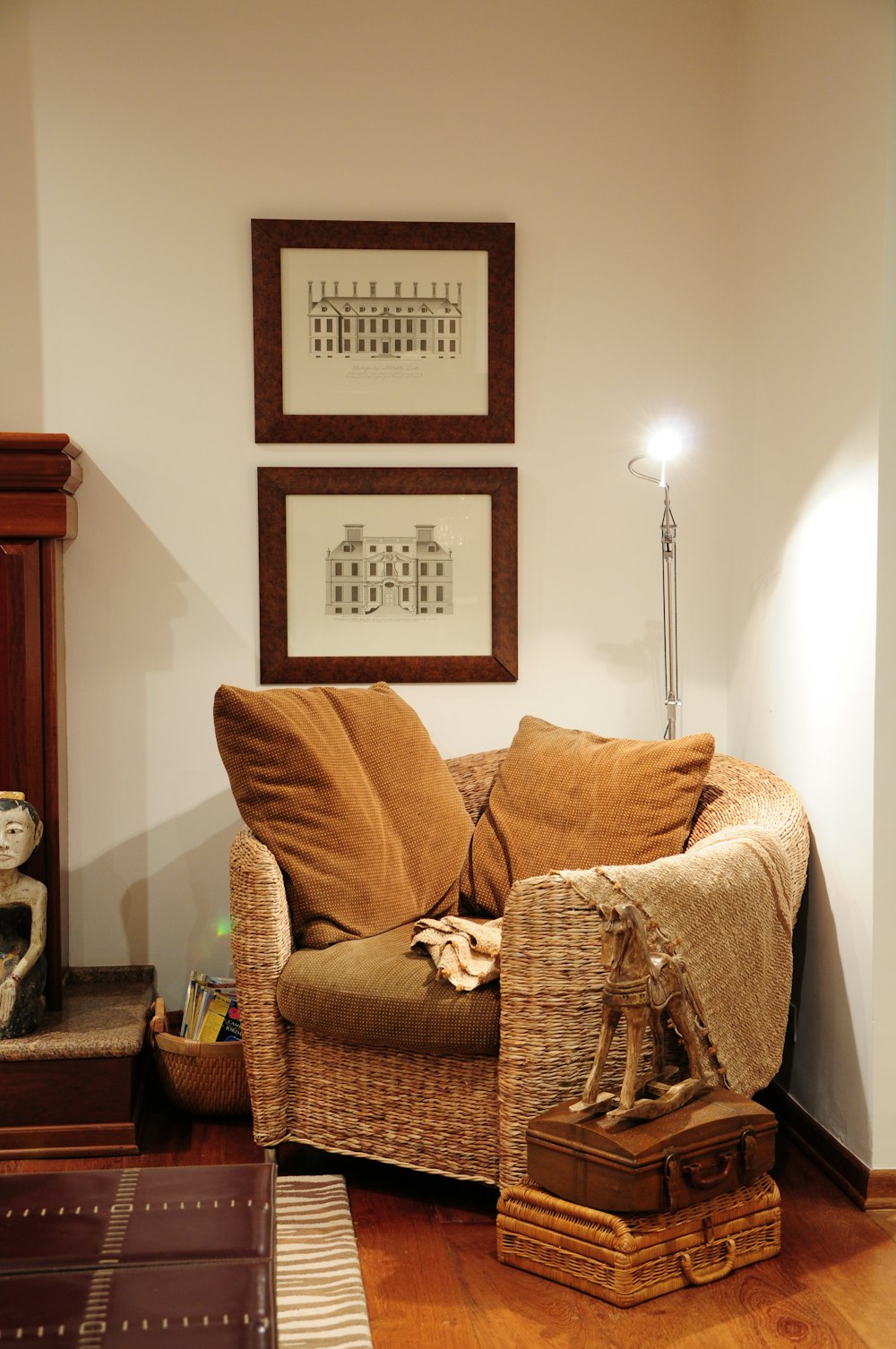 brown wicker armchair beside white wall