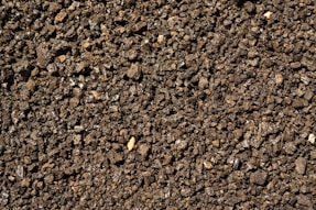 a close up of a dirt surface with small rocks