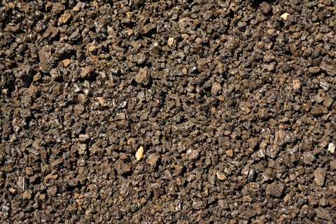 a close up of a dirt surface with small rocks