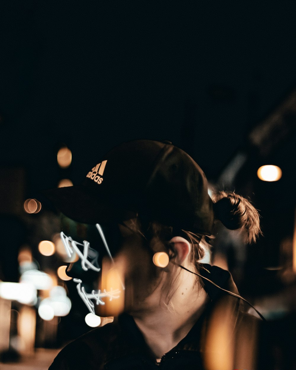 woman in black cap and black shirt