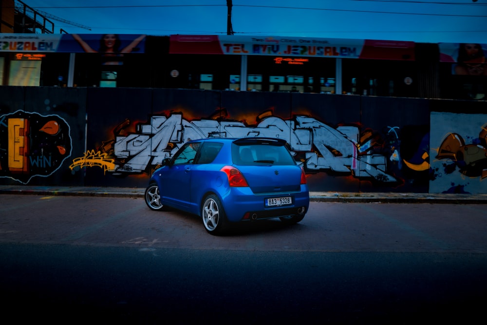 blue car parked in front of blue and white cars during daytime