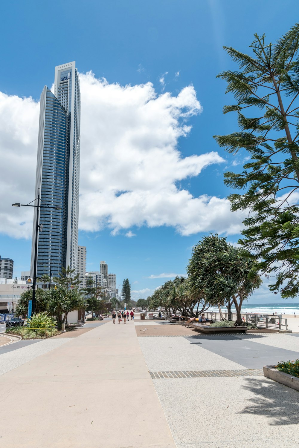 a view of a beach with a tall building in the background