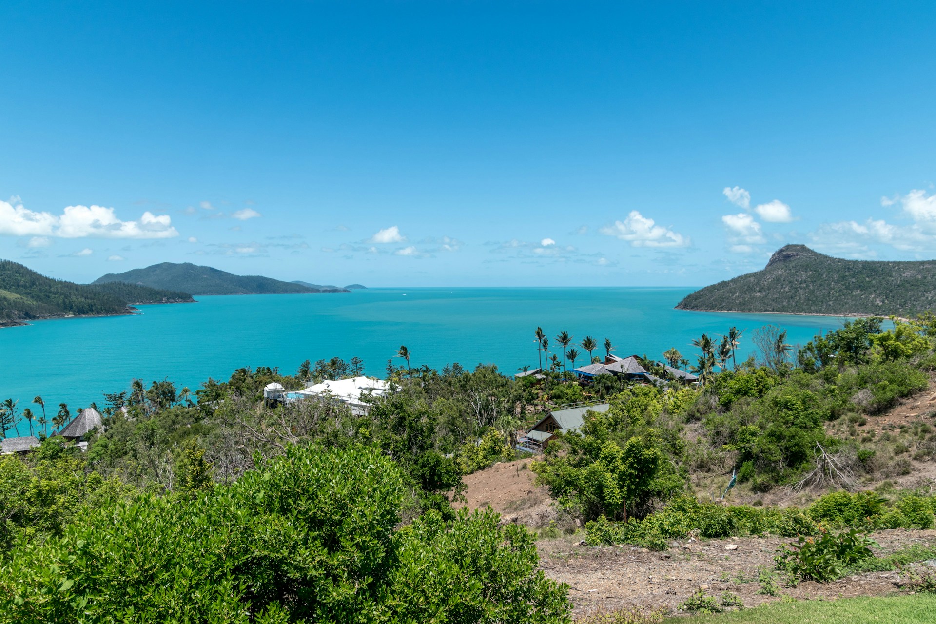 woman wearing yellow long-sleeved dress under white clouds and blue sky during daytime