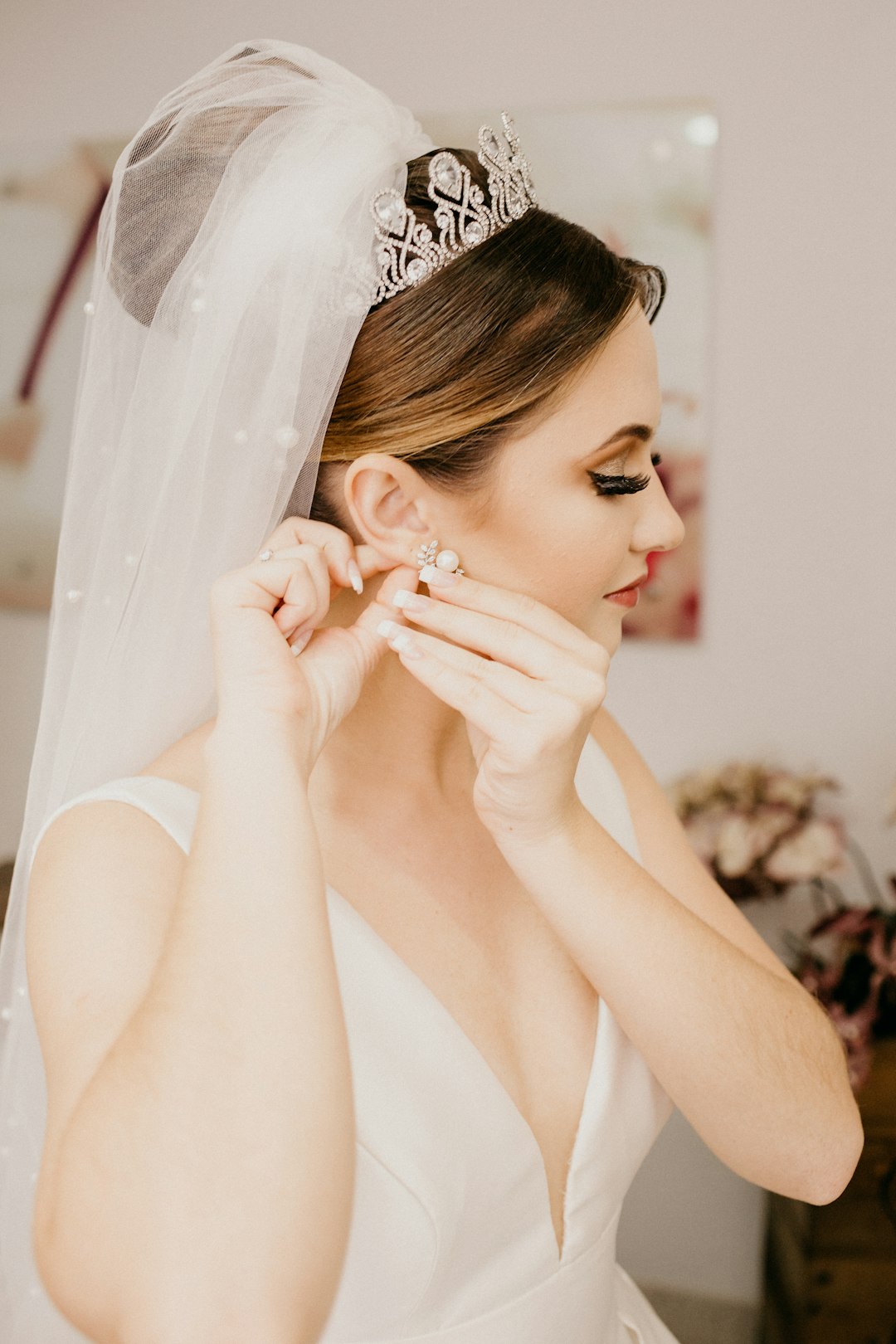 woman in white sleeveless dress wearing silver tiara