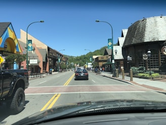A busy street with cars and shops in the background.