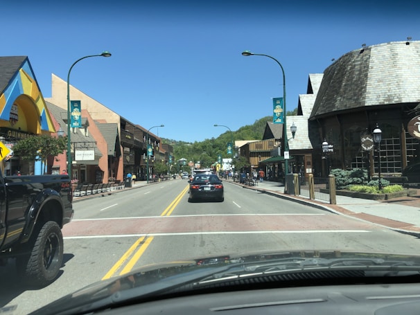 A busy street with cars and shops in the background.