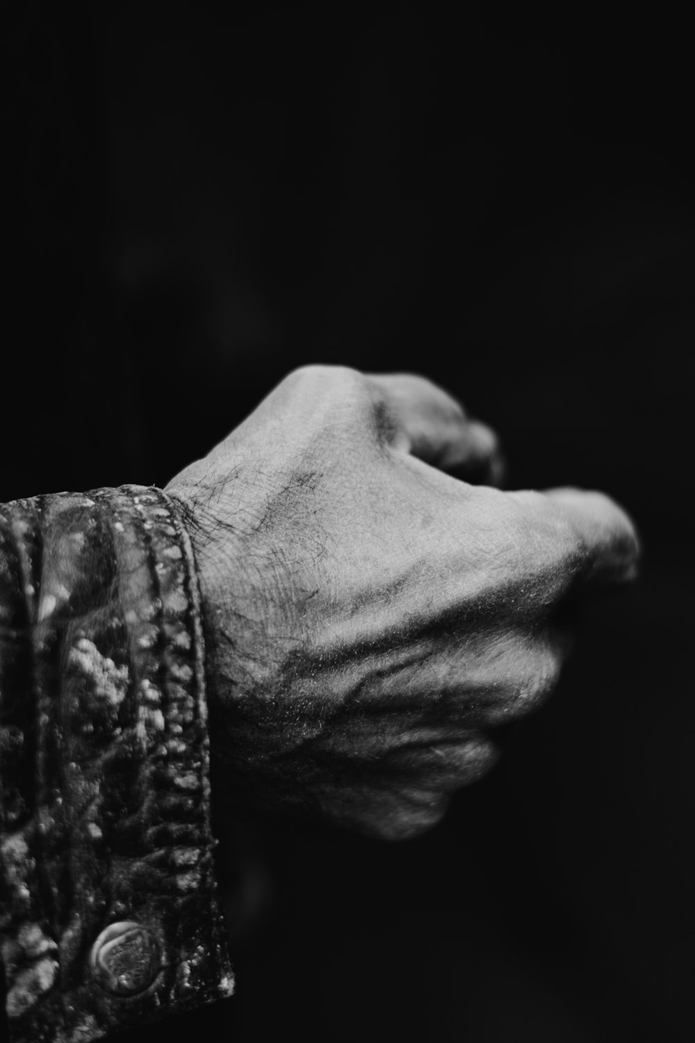 grayscale photo of persons hand