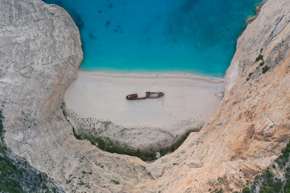 brown rock formation near body of water during daytime