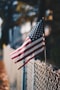 us a flag on gray metal fence during daytime