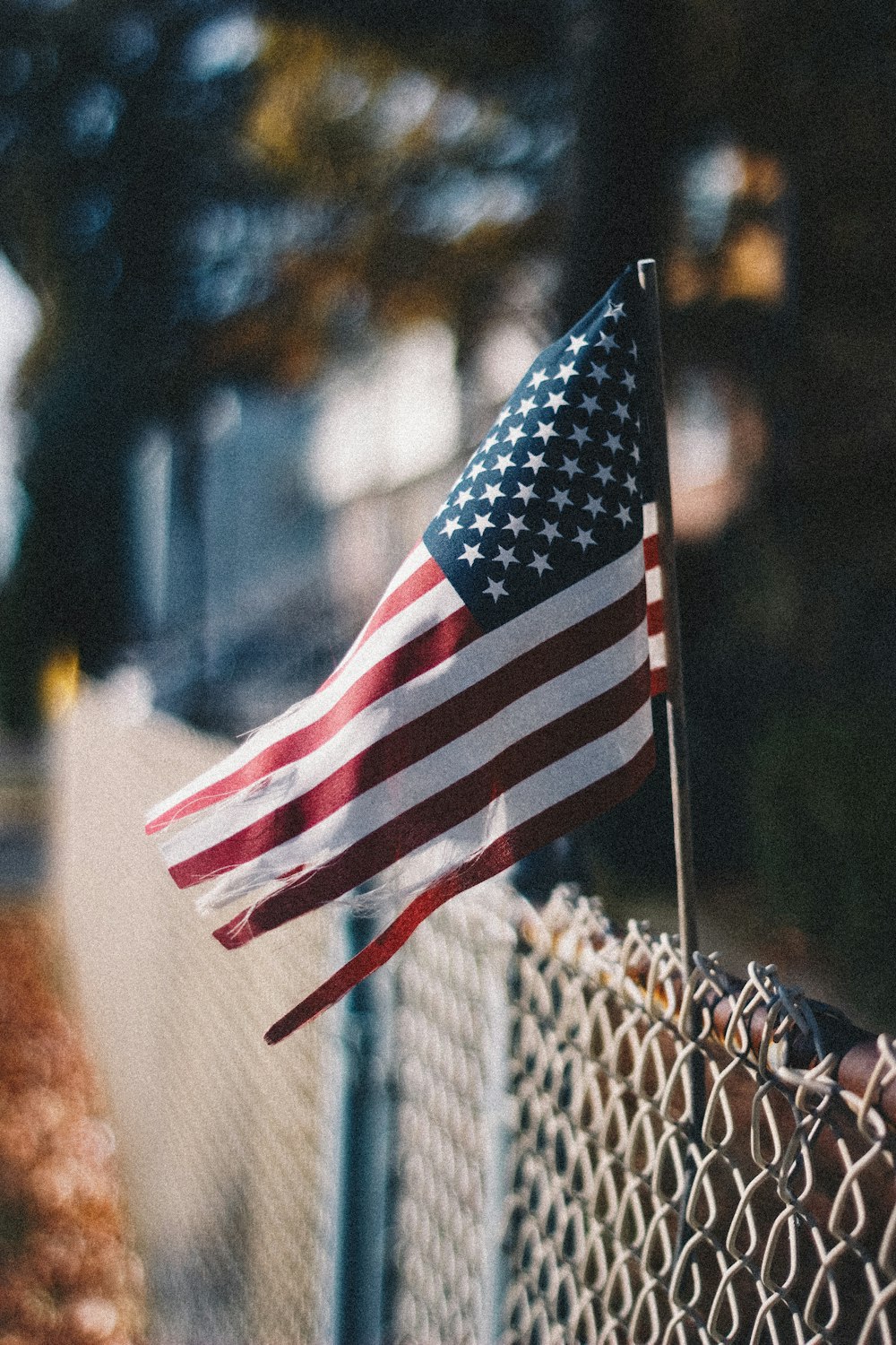 us a flag on gray metal fence during daytime