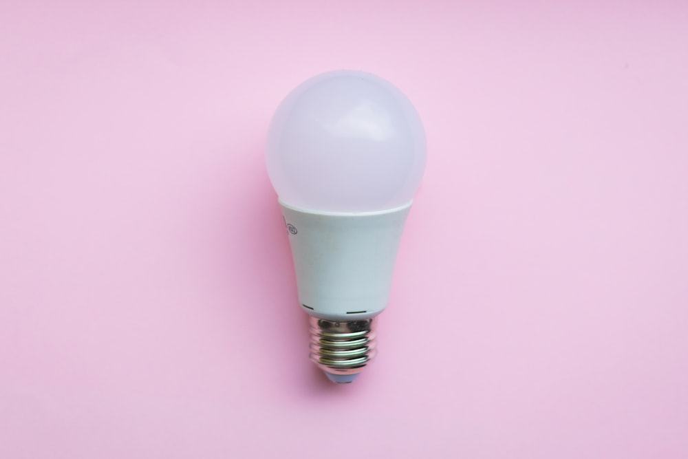 white light bulb on pink surface
