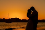 silhouette of man and woman kissing during sunset