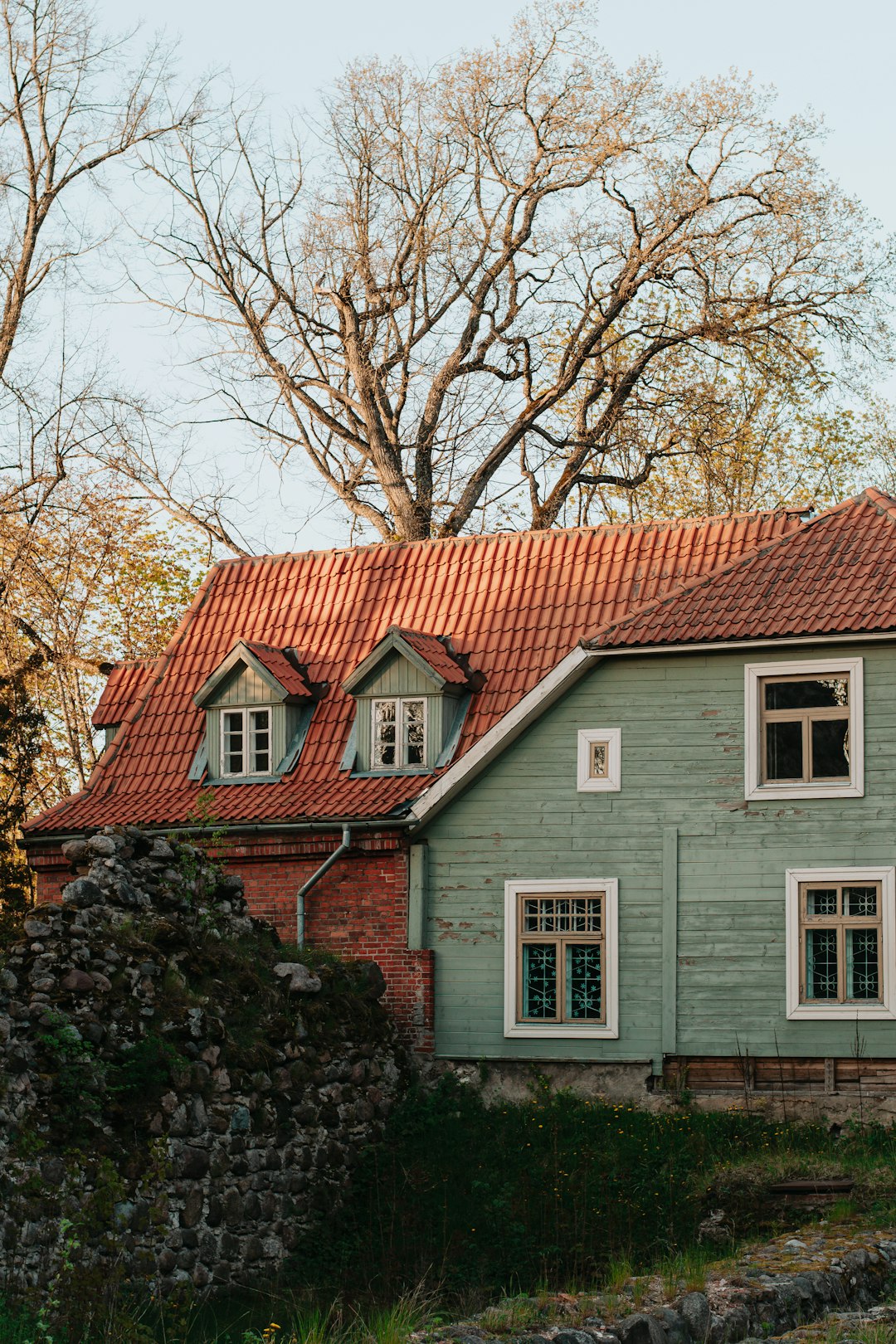 white and brown concrete house near brown trees during daytime