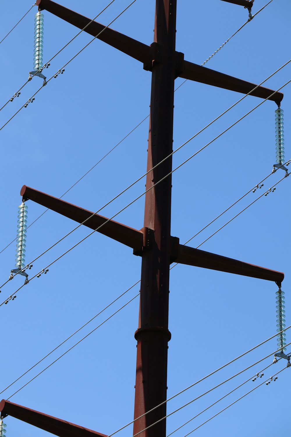 brown wooden post with wires