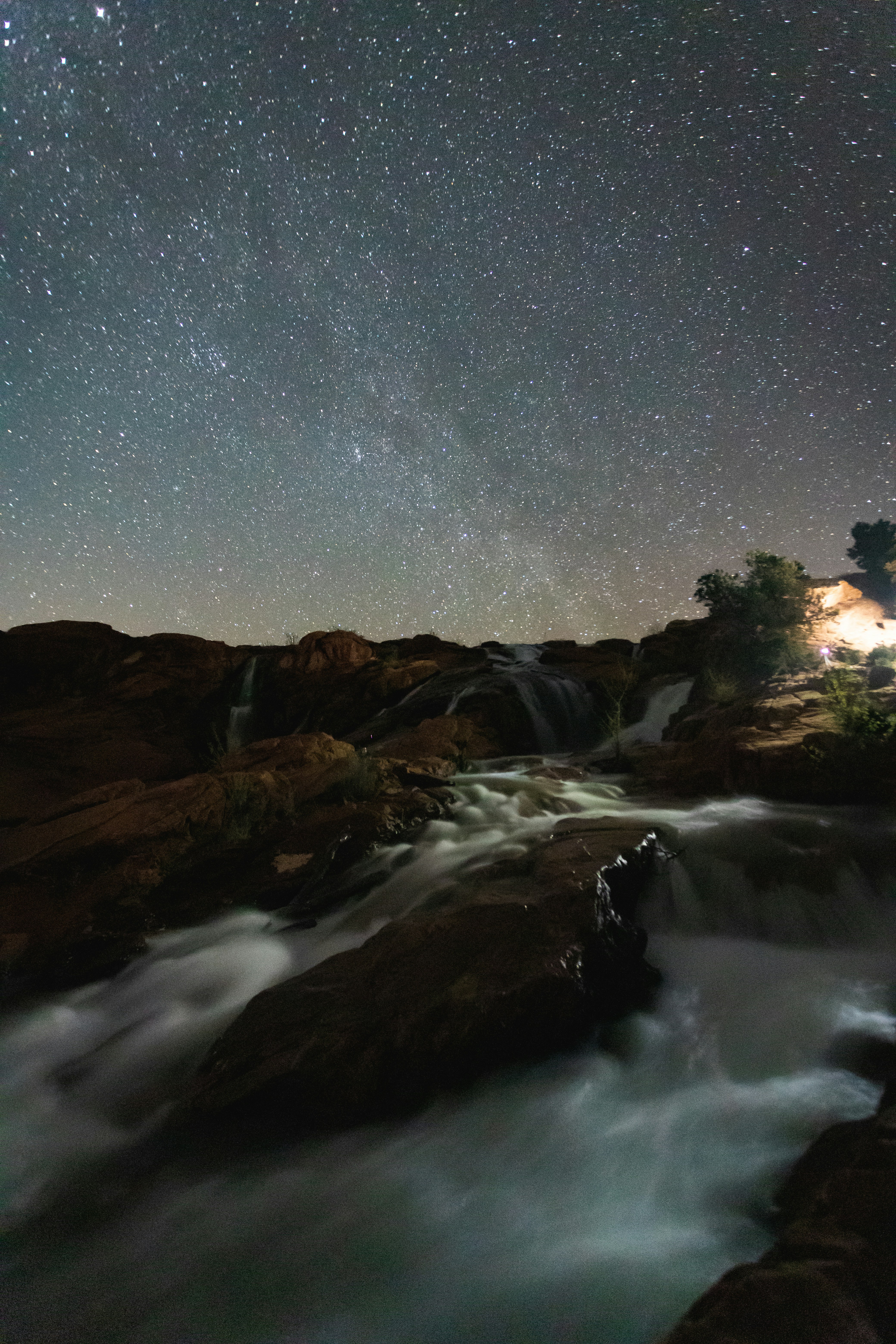 brown and green mountains under blue sky during night time