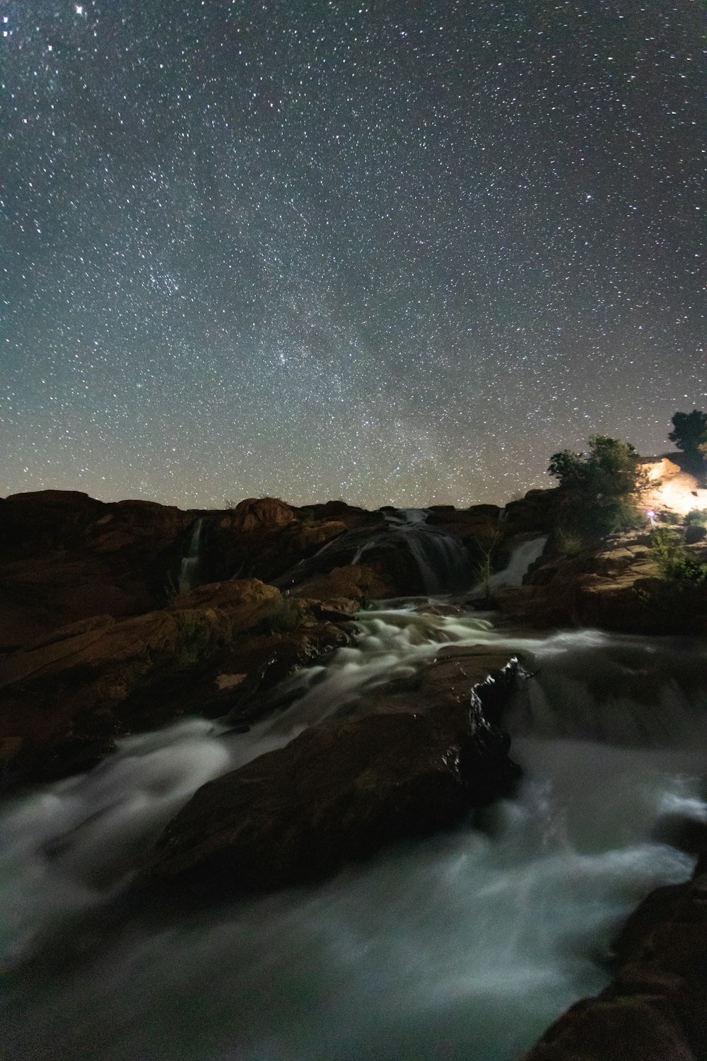 brown and green mountains under blue sky during night time