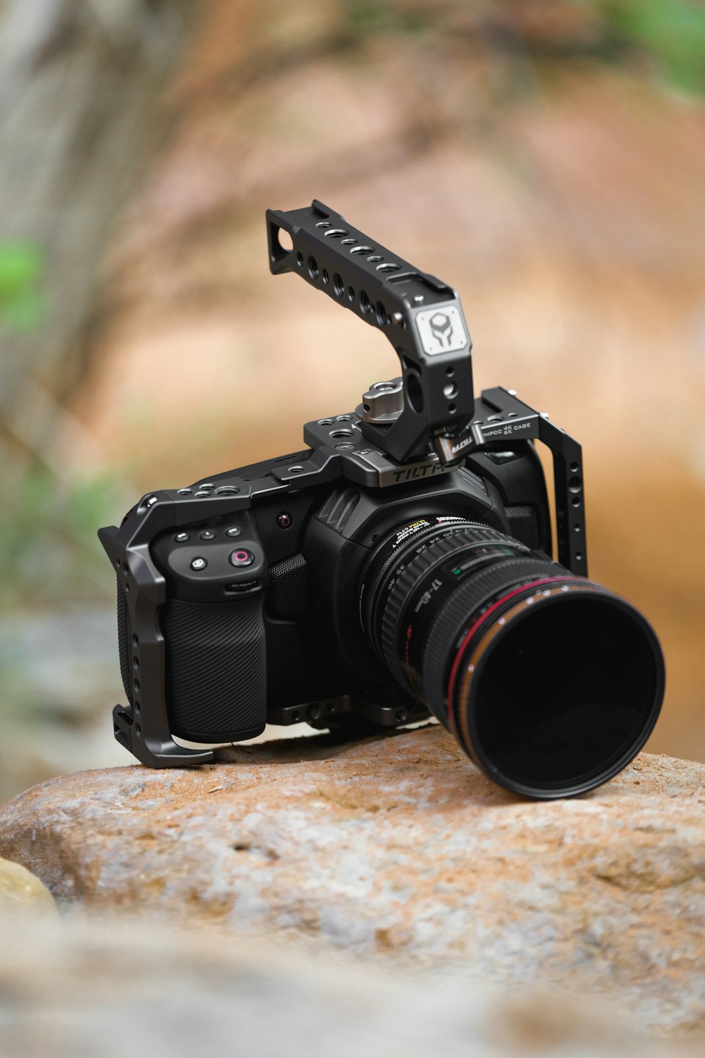 black nikon dslr camera on brown rock