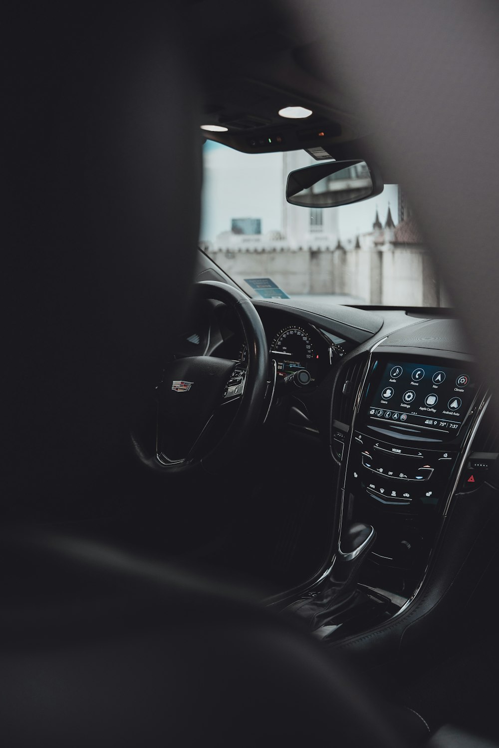 black car steering wheel during daytime