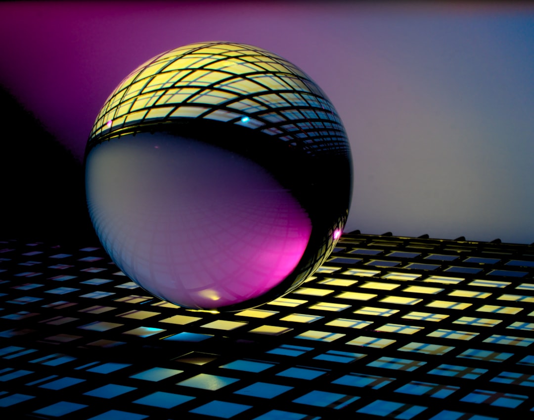 blue and black ball on blue and white checkered textile, Glass Orb with Patterns