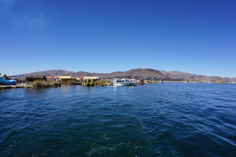 body of water near city buildings under blue sky during daytime