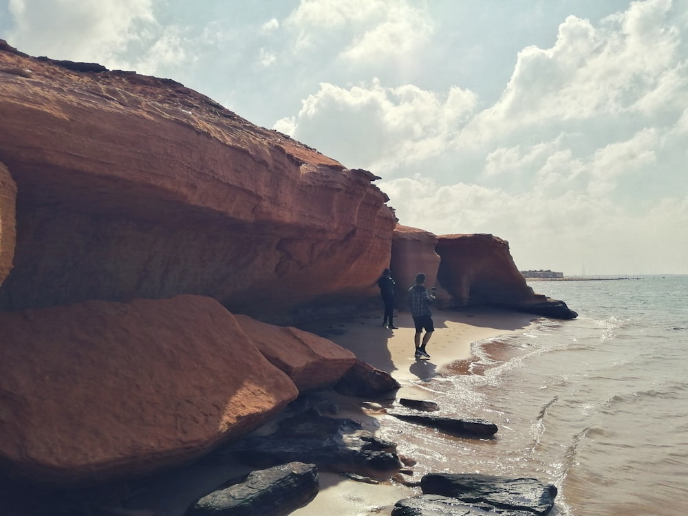 people walking on beach shore during daytime