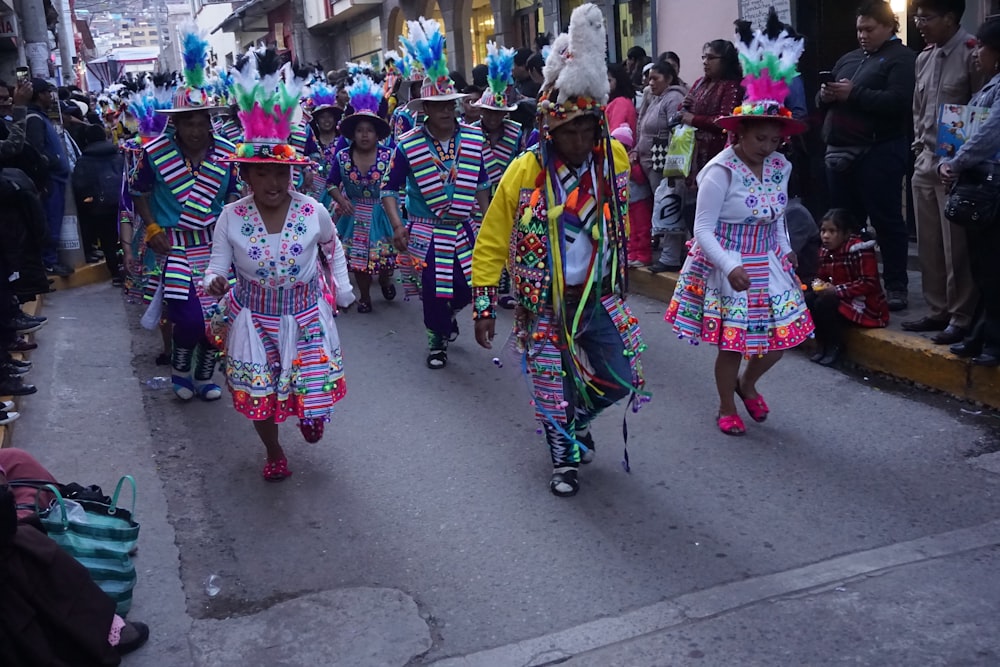 people in traditional dress walking on street during daytime