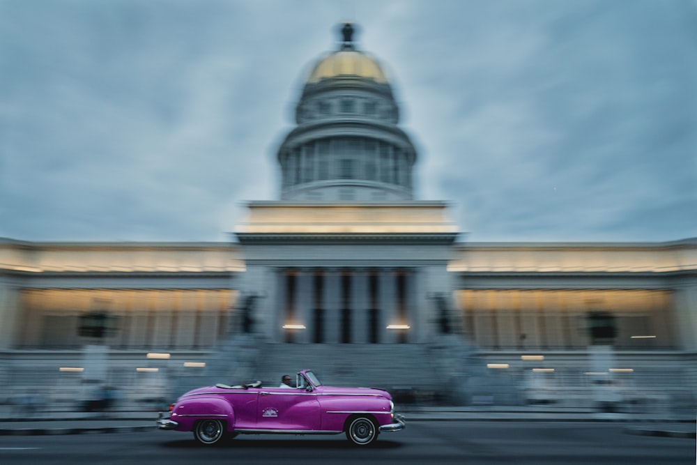 purple car on road near building during daytime