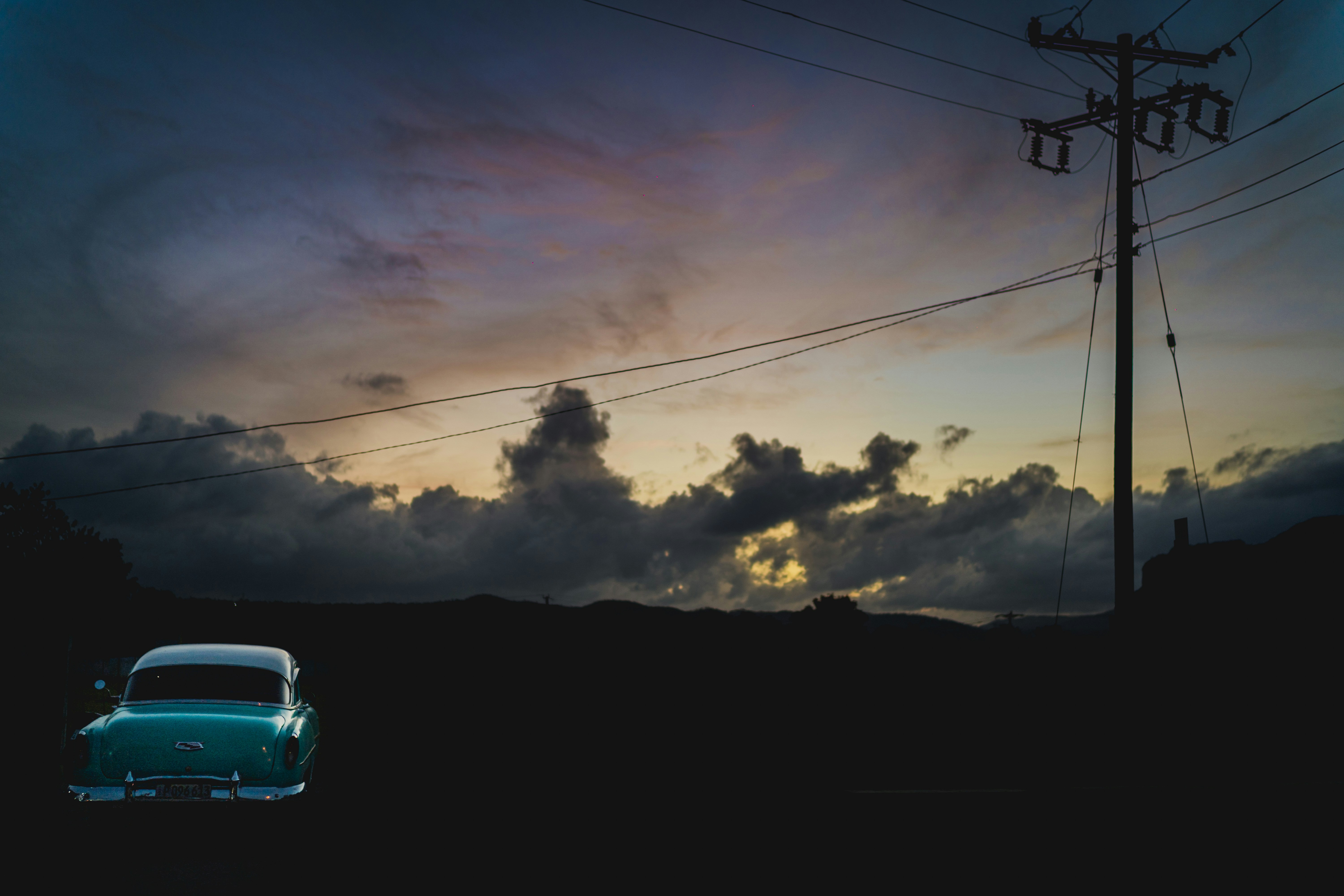 white car on road under cloudy sky
