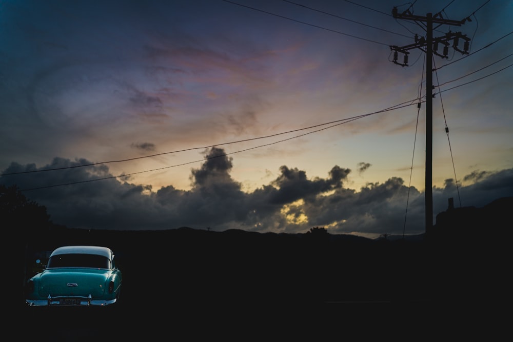 white car on road under cloudy sky