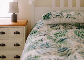 white and green floral bed linen