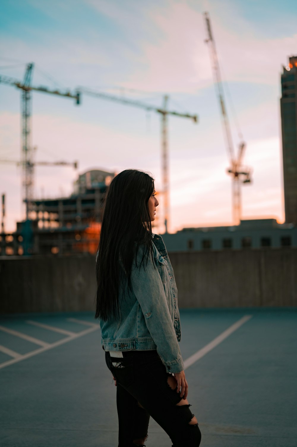 woman in blue denim jacket standing on basketball court during daytime