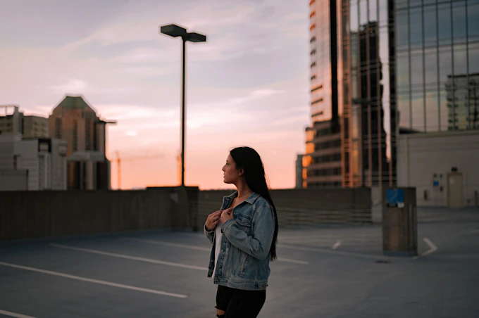 woman in gray long sleeve shirt on a city sidewalk