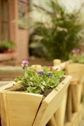 A custom-built wooden planter box filled with vibrant seasonal flowers.